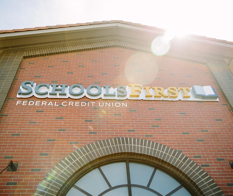 Photo of the SchoolsFirst FCU name on the exterior of the Crocker Village branch.