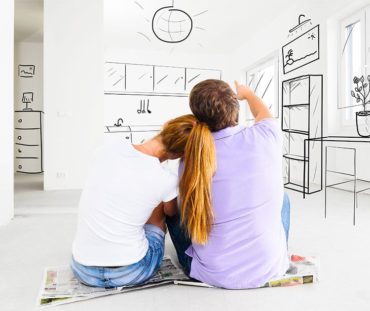 A couple sitting on the floor looking at a white wall with an imaginary illustration the interior design of the house.