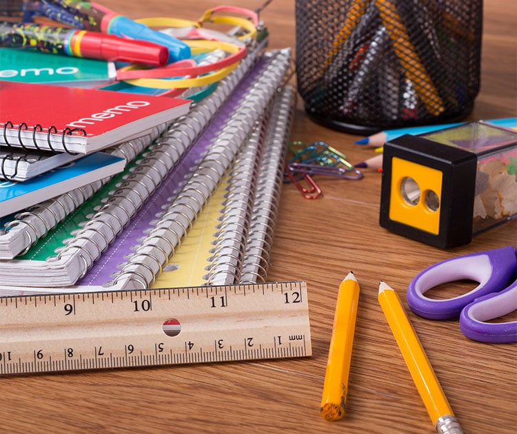 Photo of school supplies on a desk.