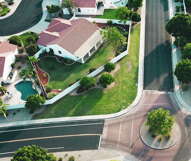 An overhead view of urban neighborhood overlooking homes and streets.