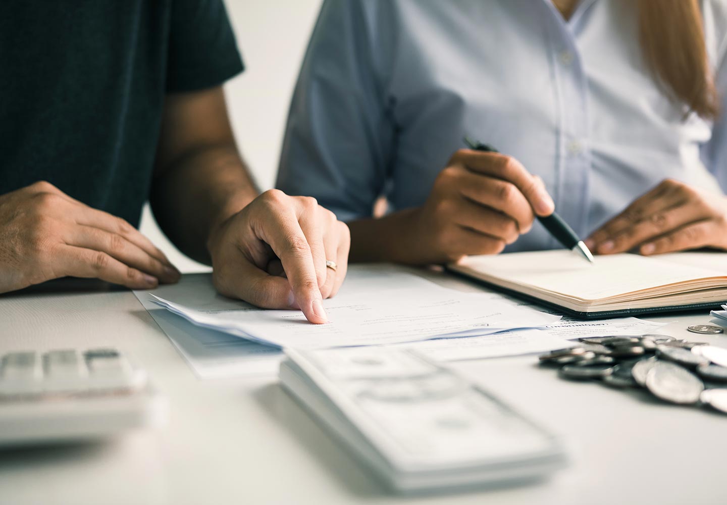 A couple are together analyzing expenses or finances.