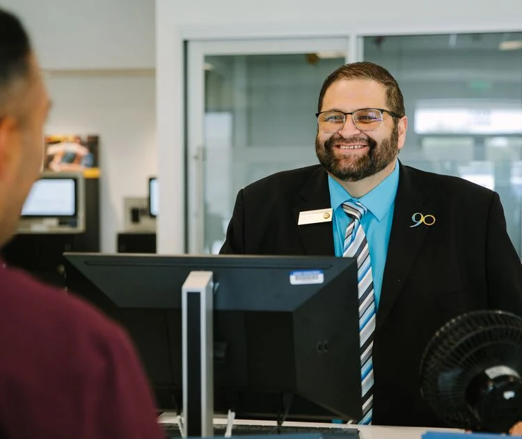 A SchoolsFirst FCU teammember ready to serve a Member.